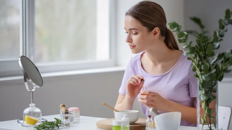 Woman mixing cosmetic ingredients at a table